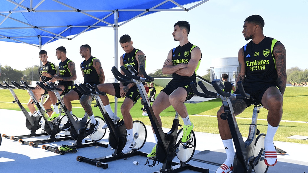 The Arsenal squad on exercise bikes before training in Dubai